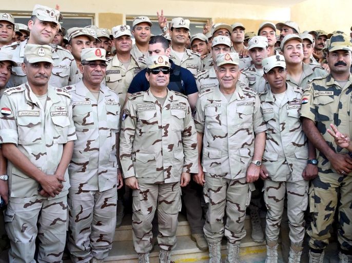 Egyptian President Abdel Fattah al-Sisi (front 3rd L) poses for a photograph with members of the Egyptian armed forces, after travelling to the troubled northern part of the Sinai peninsula to inspect troops, in this July 4, 2015 handout picture courtesy of the Egyptian Presidency. Egypt’s military killed 35 Islamist militants in North Sinai on Thursday, security sources said, a day after the deadliest clashes in the region in years. The sources said those killed had taken part in Wednesday's fighting in which the army said 100 militants and 17 soldiers were killed. The sources said Thursday's casualties included militant field commanders. REUTERS/The Egyptian Presidency/Handout via Reuters ATTENTION EDITORS - THIS PICTURE WAS PROVIDED BY A THIRD PARTY. REUTERS IS UNABLE TO INDEPENDENTLY VERIFY THE AUTHENTICITY, CONTENT, LOCATION OR DATE OF THIS IMAGE. THIS IMAGE HAS BEEN SUPPLIED BY A THIRD PARTY. IT IS DISTRIBUTED, EXACTLY AS RECEIVED BY REUTERS, AS A SERVICE TO CLIENTS. FOR EDITORIAL USE ONLY. NOT FOR SALE FOR MARKETING OR ADVERTISING CAMPAIGNS. NO SALES. NO ARCHIVES.