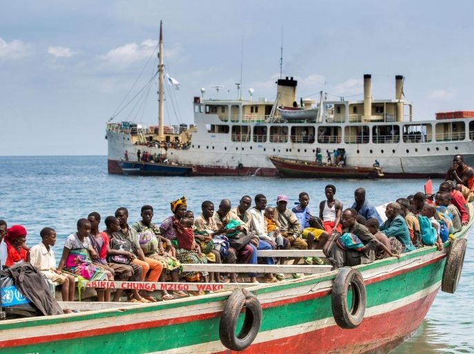 Refugees from Burundi who fled the ongoing violence and political tension sail on a boat to reach MV Liemba, a ship freighted by the United Nations at the Kagunga landing base on the shores of Lake Tanganyika near Kigoma in Tanzania, in this May 26, 2015 handout photo by PLAN INTERNATIONAL. East African leaders will meet on Sunday to discuss the crisis in Burundi as violent clashes between police and anti-government protesters continue and the opposition has boycotted talks to resolve the stand-off. The MV Liemba has played a pivotal role in helping to move thousands of refugees down the lake to Kigoma from where they start their move first to the transit camps at the Lake Tanganiyka football stadium in Kigoma and then onto Nyarugusus refugee camp. Picture taken May 26, 2015. REUTERS/Sala Lewis/PLAN INTERNATIONAL/Handout via Reuters ATTENTION EDITORS - THIS PICTURE WAS PROVIDED BY A THIRD PARTY. REUTERS IS UNABLE TO INDEPENDENTLY VERIFY THE AUTHENTICITY, CONTENT, LOCATION OR DATE OF THIS IMAGE. FOR EDITORIAL USE ONLY. NOT FOR SALE FOR MARKETING OR ADVERTISING CAMPAIGNS.