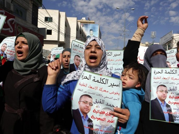 Palestinians hold placards during a protest to support Mohammad AL-Qeeq in the West bank city of Hebron, 05 February 2016. The Israeli court suspended the administrative arrest for Al-Qeeq after his medical condition reached a critical level due to his 73 days on hunger strike, he will continue the hunger strike until he gets free, the family of Al-Qeeq said. The Palestinian journalist Al-Qeeq is protesting being held without trial or specific charges. His health has deteriorated so much that Israeli authorities decided to force feed him.