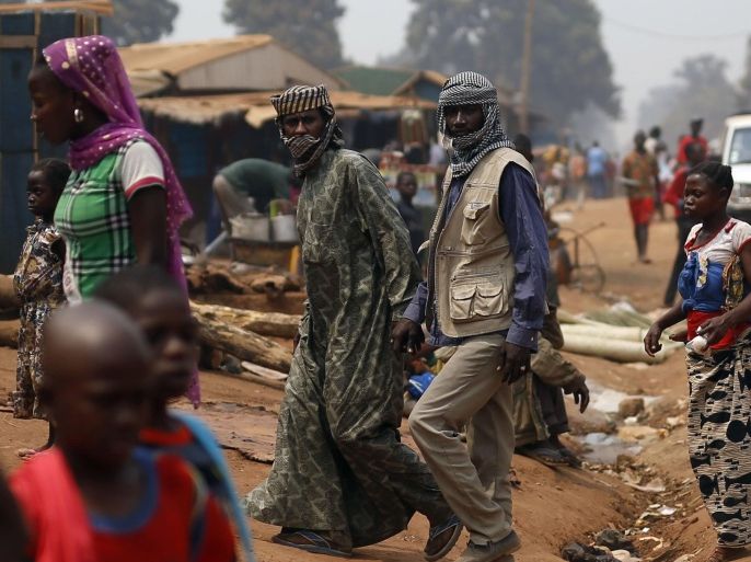 Muslim herders walk through the market in Kaga-Bandoro, Central African Republic, Tuesday Feb. 16, 2016. Refugees in the north of Central African Republic say they hope the new president will bring peace but no one is heading home just yet. Thousands are still living in displacement camps in Kaga-Bandoro, a stronghold of the former Muslim rebel group known as Seleka that was in power for nearly a year. The one-time rebels say they are waiting to see how the election turns out before taking any action. (AP Photo/Jerome Delay)