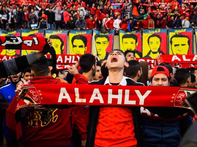 A supporter holds a scarf of 'Al Ahly' soccer club as fans gather around photos depicting some of the victims killed in the Port Said soccer match riots, on the fourth anniversary at the Al-Ahly football club in Cairo, Egypt, 01 February 2016. Seventy-four soccer fans died on 01 February 2012 after clashes between fans of Port Said's al-Masry team and visiting Cairo team al-Ahly.
