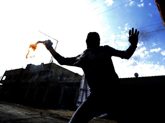 Palestinian protester throws a molotov cocktail at Israeli soldiers during clashes at the West Bank village of Qabatiya, near Jenin, 05 February 2016. The clashes erupted between Palestinian residents and the Israeli military 05 February, a day after forces raided the northern West Bank hometown of three militants who had launched a shooting and stabbing attack in Jerusalem the previous day. Israeli military closed off roadblocks and checkpoints in and out of the town while soldiers prepared punitive measures to raze the homes of the three attackers. At least four Palestinians were injured, including a 16-year-old boy who was hit by a military vehicle, the mayor of the town of Qabatiya, Mahmoud Kmeil, said