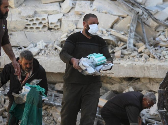 People carry medical supplies found under the rubble of a destroyed Medecins Sans Frontieres (MSF) supported hospital hit by missiles in Marat Numan, Idlib province, Syria, February 16, 2016. REUTERS/Ammar Abdullah