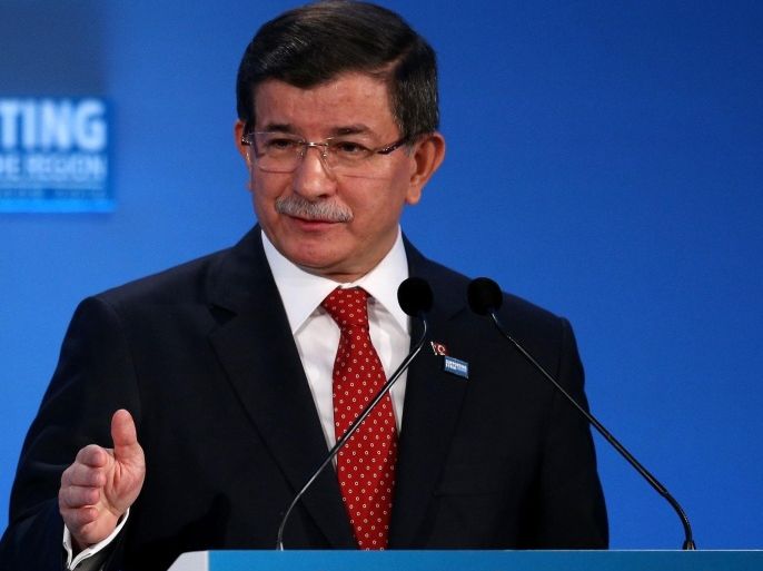 Turkey's Prime Minister Ahmet Davutoglu speaks at the 'Supporting Syria and the Region' conference at the Queen Elizabeth II Conference Centre in London, Thursday, Feb. 4, 2016. Leaders and diplomats from 70 countries are meeting in London Thursday to pledge billions to help millions of Syrians displaced by war, and try to slow the chaotic exodus of refugees to Europe. (Dan Kitwood Pool via AP)