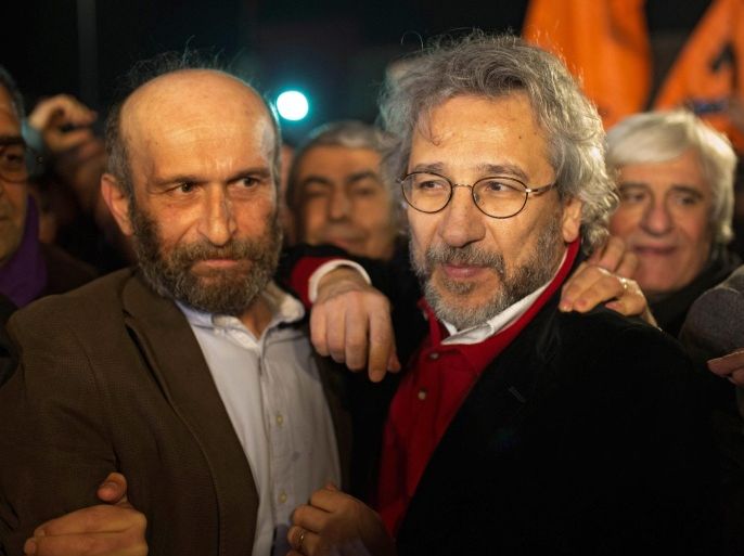 A handout picture provided by the Turkish Cumhuriyet Newspaper on 26 February 2016 shows Can Dundar (R), editor of Cumhuriyet Newspaper and Erdem Gul (L), Cumhuriyet Newspaper Ankara chief, after their release from Silivri prison in Istanbul, Turkey, early 26 February 2016. Two opposition journalists were released from jail on 26 February after a Constitutional Court ruling that their detention since November was a violation of their rights, but the pair will still face a trial on terrorism and espionage charges.Can Dundar and Erdem Gul, respectively editor-in-chief and correspondent of the left-leaning Cumhuriyet newspaper, had reported on the alleged delivery of weapons from Turkey's spy agency to suspected extremists in Syria.