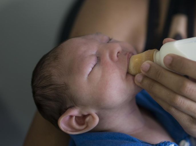 Daniele Ferreira dos Santos feeds her son Juan Pedro, who suffers from microcephaly, as they wait to be examined at the Altino Ventura Foundation, a treatment center that provides free health care, in Recife, Pernambuco state, Brazil, Thursday, Feb. 4, 2016. Brazil is in the midst of a Zika outbreak and authorities say they have also detected a spike in cases of microcephaly in newborn children, but the link between Zika and microcephaly is as yet unproven. (AP Photo/Felipe Dana)