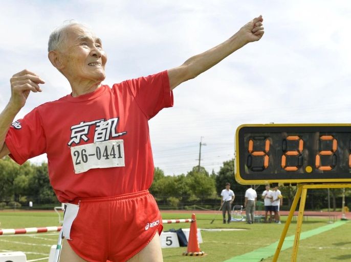 105-year-old Japanese Hidekichi Miyazaki poses like Jamaica's Usain Bolt in front of an electric board showing his 100-metre record time of 42.22 seconds at an athletic field in Kyoto, Japan, in this photo taken by Kyodo September 23, 2015. Japanese centenarian Hidekichi Miyazaki set a record as the world's oldest competitive sprinter this week, one day after turning 105, but said he was disappointed at falling short of his own personal best. Picture taken September 23, 2015. Mandatory credit REUTERS/Kyodo ATTENTION EDITORS - FOR EDITORIAL USE ONLY. NOT FOR SALE FOR MARKETING OR ADVERTISING CAMPAIGNS. THIS IMAGE HAS BEEN SUPPLIED BY A THIRD PARTY. IT IS DISTRIBUTED, EXACTLY AS RECEIVED BY REUTERS, AS A SERVICE TO CLIENTS. MANDATORY CREDIT. JAPAN OUT. NO COMMERCIAL OR EDITORIAL SALES IN JAPAN. TPX IMAGES OF THE DAY
