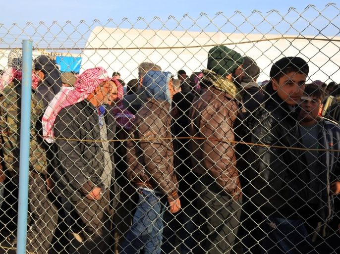 In this photo provided by Turkey's Islamic aid group of IHH, Syrians fleeing the conflicts in Azaz region, queue at the Bab al-Salam border gate, Syria, Friday, Feb. 5, 2016. Turkish officials say thousands of Syrians have massed on the Syrian side of the border seeking refuge in Turkey. Officials at the government’s crisis management agency said Friday it was not clear when Turkey would open the border to allow the group in and start processing them. The refugees who fled bombing in Aleppo, were waiting at the Bab al-Salam crossing, opposite the Turkish province of Kilis.(IHH via AP)