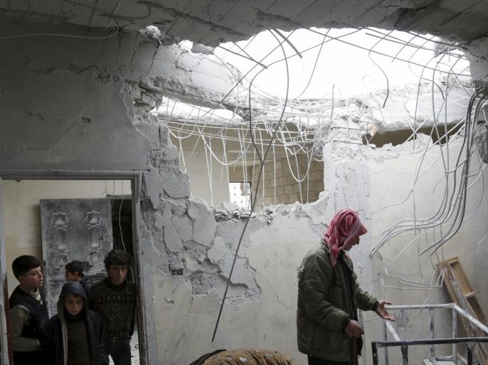 The associate director (R) of a school inspects damage inside a classroom after what activists said was an air strike carried out yesterday by the Russian air force in Injara town, Aleppo countryside, Syria January 12, 2016. Bombs dropped by suspected Russian warplanes killed at least 12 Syrian schoolchildren on Monday when they hit a classroom in a rebel-held town in Aleppo province, the Syrian Observatory for Human Rights reported. REUTERS/Khalil Ashawi