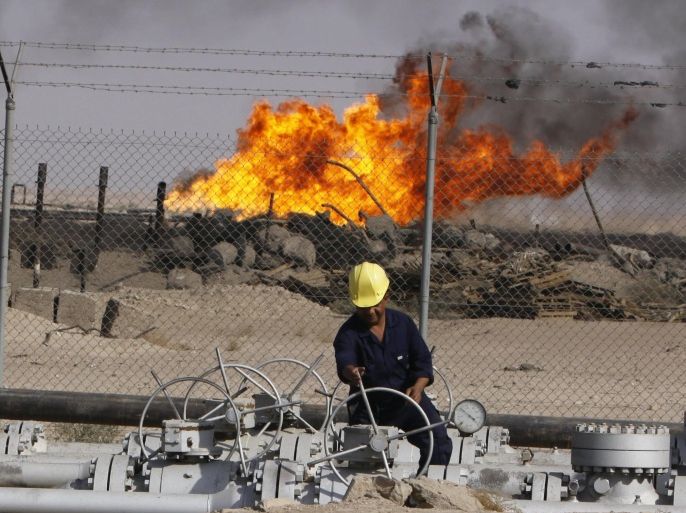 FILE - In this Dec. 13, 2009 file photo, an Iraqi worker operates valves at the Rumaila oil refinery near the city of Basra, 550 kilometers (340 miles) southeast of Baghdad, Iraq. The turmoil in Iraq has thrown the OPEC member’s ambitious plans to boost oil production into doubt, threatening to crimp its most vital economic lifeline. Northern oil fields imperiled by the militants’ advance have been shut down, and companies have begun evacuating workers elsewhere in the country. Iraq’s Kurdish minority has moved to solidify control over the northern oil-rich city of Kirkuk and other disputed areas, weakening Baghdad’s claims to the energy riches buried beneath while bolstering the Kurds’ aspirations of greater autonomy. (AP Photo/Nabil al-Jurani, File)