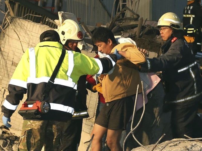 Firemen rescue a man (C) from a collapsed house in Tainan City, south Taiwan, Taiwan, 06 February 2016, following a 6.4 magnitude earthquake struck the area. At least two people, including an infant, were killed and dozens injured when a high-rise building collapsed after a 6.4-magnitude earthquake struck southern Taiwan early 06 February, authorities said. The 16-storey building in the city of Tainan was said to be home to some 200 people in 60 households, state-run media reported. Lai Ching-te, mayor of Tainan, which has a population of 2 million, confirmed the two deaths. A number of other buildings in Tainan also collapsed or were damaged in the wake of the tremor that struck the Meinung District of Kaohsiung City in southern Taiwan at 03:57 am local time (19:57 GMT Friday). There were several aftershocks in southern Taiwan. The total number of victims remained unclear. Emergency crews worked in the darkness to rescue those still trapped in rubble. The effects of the earthquake were felt throughout the island when most of its inhabitants were asleep. EPA/JOHNSON LIU -- ALTERNATIVE CROP -- TAIWAN OUTEDITORIAL USE ONLY / NO SALES