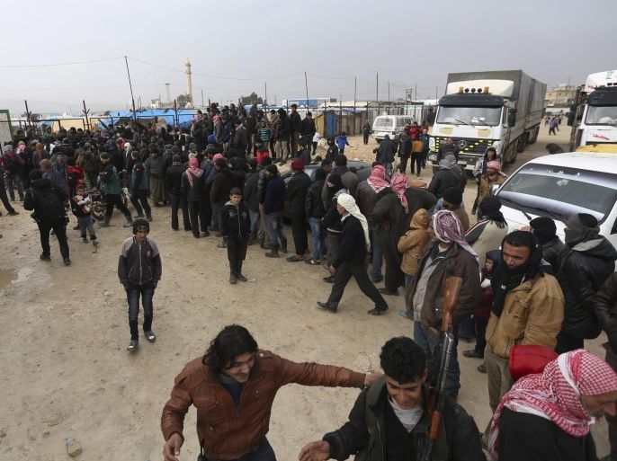 Syrians gather at the Bab al-Salam border gate with Turkey, in Syria, Saturday, Feb. 6, 2016. Some thousands of Syrians have rushed toward the Turkish border, fleeing fierce Syrian government offensives and intense Russian airstrikes. Turkey has promised humanitarian help for the displaced civilians, including food and shelter, but it did not say whether it would let them cross into the country. (AP Photo/Bunyamin Aygun) TURKEY OUT