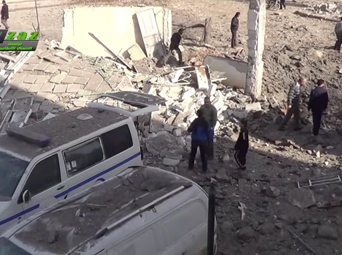 This image taken from video provided by the Syrian activist-based media group Azaz Media Center, which has-been verified and is consistent with other AP reporting, shows people gathered around destroyed vehicles in Azaz, Syria Syria, Monday, Feb. 15, 2016. Turkey says Kurdish forces have been expelled from areas around the northern Syrian town of Azaz after a weekend of cross-border shelling.(Azaz Media Center,via AP Video) MANDATORY CREDIT