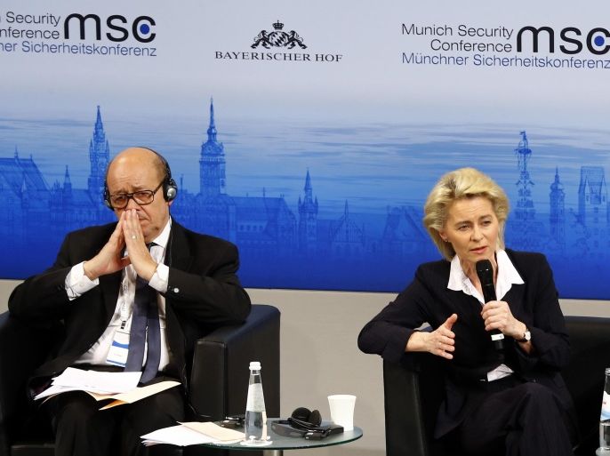 German Minister of Defense, Ursula von der Leyen, right, gestures on the podium besides French Minister of Defense, Jean-Yves Le Drian at the Munich Security Conference in Munich, Germany, Friday, Feb. 12, 2016. (AP Photo/Matthias Schrader)