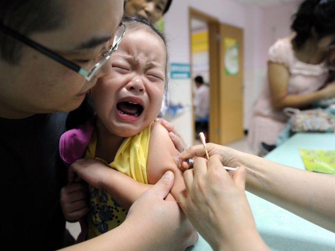 In this Sept. 11, 2010 photo, a child cries while receiving a shot of measles vaccine at a health station in Hefei in central China's Anhui province. China’s Food and Drug Administration has ordered local governments to track the whereabouts of poorly refrigerated and probably ineffective vaccines after police detained a woman thought to have sold nearly $100 million worth of the suspect products nationwide. (Chinatopix via AP) CHINA OUT
