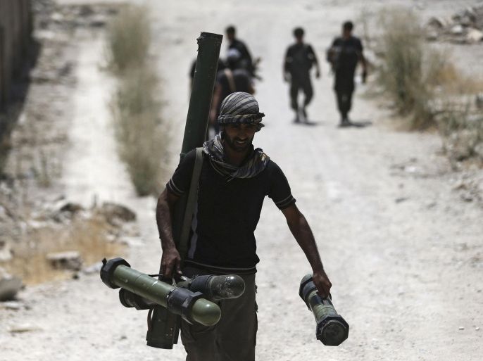 A fighter from the Free Syrian Army's Al Rahman legion carries a weapon as he walks towards his position on the front line against the forces of Syria's President Bashar al-Assad in Jobar, a suburb of Damascus, Syria, in this July 27, 2015 file photo. Only four or five U.S.-trained Syrian rebels were still fighting in Syria, a top general told Congress on September 16, 2015, a stark admission of setbacks to a fledgling military program that critics have already pronounced a failure. REUTERS/Bassam Khabieh/Files
