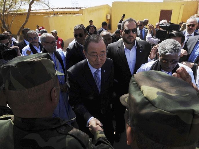 United Nations secretary-general Ban Ki-moon shakes hands with Algerian soldiers as he arrives in the Smara refugees camp near Tindouf, south-western Algeria, Saturday, March 5, 2016. Ban Ki-moon will meet with leaders of the Polisario Front, the organization disputing sovereignty over Western Sahara with Morocco, in the hope to help solving a 40-year conflict. (AP Photo/Toufik Doudou)