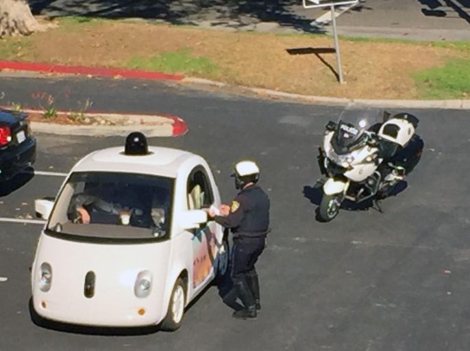 In this Thursday, Nov. 12, 2015 photo provided by Zandr Milewski, a California police officer pulls over a self-driving car specially designed by Google that was being tested on a local road in Mountain View, Calif. The police officer saw the car going a road-clogging 24 mph in a 35 mph zone and realized it was a Google Autonomous Vehicle. After getting closer to it he noticed that there was no one actually driving the car. The officer stopped the car and contacted the person behind the wheel to say the vehicle was impeding traffic, but he didn't give out a citation. (Zandr Milewski via AP)