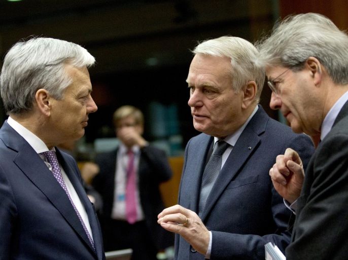 Belgian Foreign Minister Didier Reynders, left, speaks with Italian Foreign Minister Paolo Gentiloni, right, and French Foreign Minister Jean-Marc Ayrault during a meeting of EU foreign ministers at the EU Council building in Brussels on Monday, March 14, 2016. EU foreign ministers on Monday will discuss Iran, Russia and the current situation in Libya. (AP Photo/Virginia Mayo)