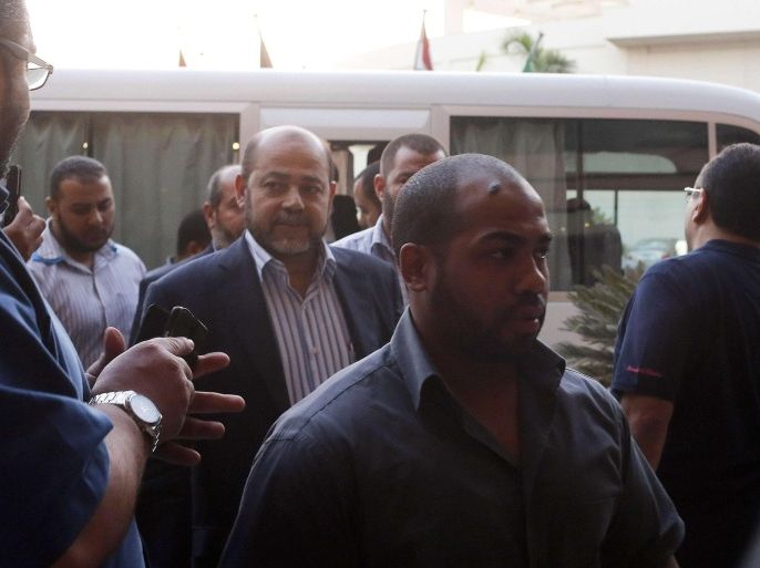Senior Hamas official and delegation leader Moussa Abu Marzouk (C) and other Palestinian negotiators arrive at a hotel after negotiations in Cairo August 13, 2014. The threat of renewed war in Gaza loomed on Wednesday as the clock ticked toward the end of a three-day ceasefire with no sign of a breakthrough in indirect talks in Cairo between Israel and the Palestinians. REUTERS/Asmaa Waguih (EGYPT - Tags: POLITICS CONFLICT CIVIL UNREST)