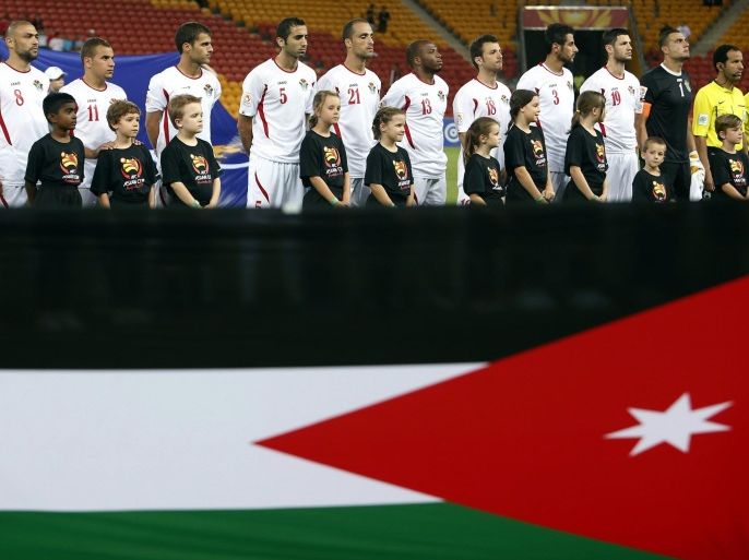 Members of the Jordanian team stand with officials behind their national flag before the start of the Asian Cup Group D soccer match against Iraq at the Brisbane Stadium in Brisbane January 12, 2015. REUTERS/Edgar Su (AUSTRALIA - Tags: SPORT SOCCER)