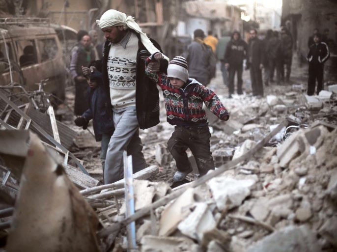 In this Dec. 24, 2015 photo provided by Save the Children, a man walks with a pair of children in hand hand through the rubble in Eastern Ghouta, Syria. A report published Tuesday, March 8, 2016, by Save the Children, paints a grim picture in Syria's besieged cities, where young people have lost any hope for the future, living in constant fear of aerial bombardment and lacking access to food and proper medical care. (Save the Children via AP)
