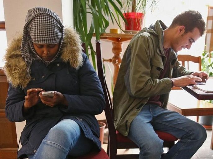 two persons using mobile phone and labtop (Getty images)