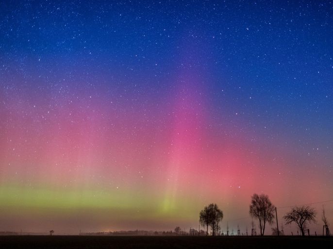In this long-time exposed March 6, 2016 photo polar lights illuminate the night sky near Lietzen, eastern Germany. The Northern Lights (Aurora borealis) are produced in the earth's atmosphere by a giant cloud of electrically-charged parts of a solar storm. The color effect has been increased with a 10-second exposure. The polar light could be seen in many parts of Germany last night. (Patrick Pleul/dpa via AP)