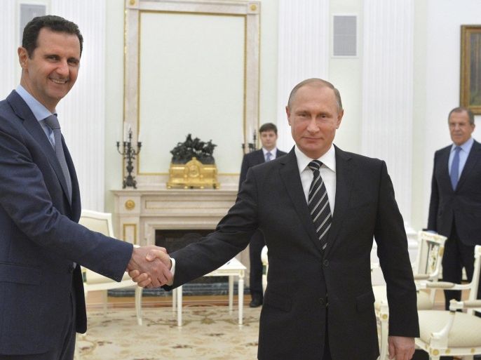 Russian President Vladimir Putin (R) shakes hands with Syrian President Bashar al-Assad during a meeting at the Kremlin in Moscow, Russia, in this October 20, 2015 file photo. To match Insight MIDEAST-CRISIS-SYRIA/PUTIN REUTERS/Alexei Druzhinin/RIA Novosti/Kremlin/ Files ATTENTION EDITORS - THIS IMAGE HAS BEEN SUPPLIED BY A THIRD PARTY. IT IS DISTRIBUTED, EXACTLY AS RECEIVED BY REUTERS, AS A SERVICE TO CLIENTS. TPX IMAGES OF THE DAY