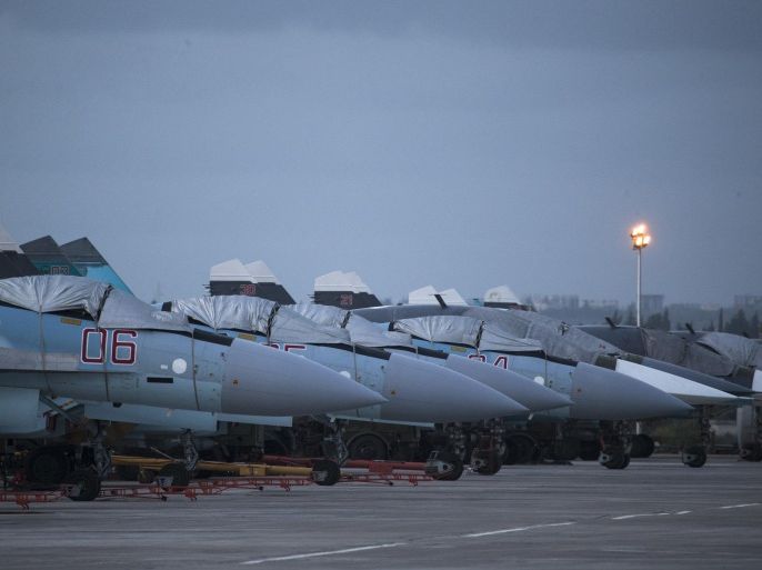 Russian fighter jets and bombers are parked at Hemeimeem air base in Syria, Friday, March 4, 2016. Russian warplanes have mostly stayed on the ground since the Russian- and U.S.-brokered cease-fire has begun last weekend. (AP Photo/Pavel Golovkin)