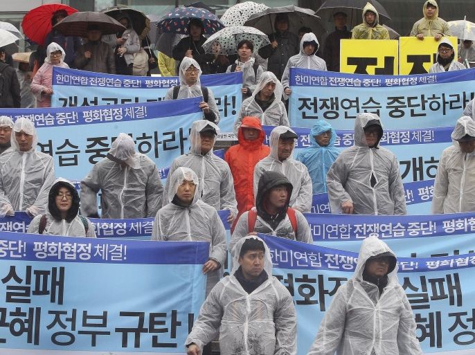 South Korean protesters stage a rally criticizing U.N. sanction on North Korea and upcoming joint military exercises between the U.S. and South Korea, in Seoul, South Korea, Saturday, March 5, 2016. North Korean leader Kim Jong Un ordered his military on standby for nuclear strikes at any time, state media reported Friday, an escalation in rhetoric targeting rivals Seoul and Washington that may not yet reflect the country's actual nuclear capacity. The banners read " Stop the joint military exercises between the U.S. and South Korea." and "Park Geun-hye, step down." (AP Photo/Ahn Young-joon)