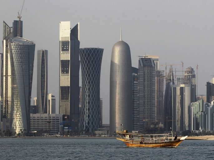 FILE - In this Thursday Jan. 6, 2011 file photo, a traditional dhow floats in the Corniche Bay area with tall buildings of the financial district in the background, a day ahead of the start of AFC Asian Cup soccer tournament in Doha, Qatar. The explosions rocking the Gaza Strip may seem far removed from the flashy cars and skyscrapers of ultra-rich Qatar, but efforts to end fighting between Hamas and Israel could hinge on how the tiny Gulf state wields its influence over a militant group with few friends left. (AP Photo/Saurabh Das, File)