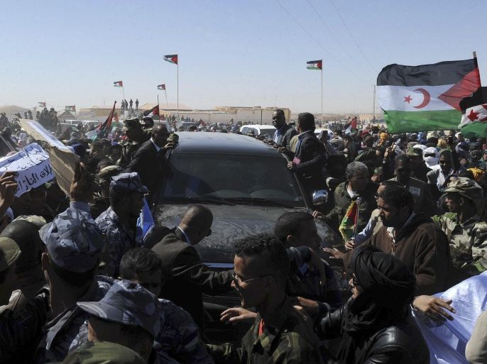 United Nations secretary-general Ban Ki-moon's car is surrounded by a crowd as he arrives in the Smara refugees camp near Tindouf, south-western Algeria, Saturday, March 5, 2016. Ban Ki-moon will meet with leaders of the Polisario Front, the organization disputing sovereignty over Western Sahara with Morocco, in the hope to help solving a 40-year conflict. (AP Photo/Toufik Doudou)