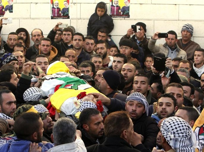 Palestinians carry the body of Ali Taqatqah, 19, during his funeral in the village of Beit Fajjar, near the West Bank city of Bethlehem. Sunday, March 20, 2016. Taqatqah and another Palestinian stabbed an Israeli soldier Thursday before Israeli troops killed them at a junction in the northern West Bank, the army said. (AP Photo/Mahmoud Illean)