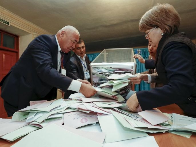 Members of a local election committee empty a ballot box to count votes after a snap parliamentary election in Kyzylorda, Kazakhstan, March 20, 2016. REUTERS/Shamil Zhumatov