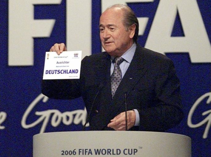 FILE - In this July 6, 2000 file picture FIFA president Sepp Blatter displays the card carrying the name of Germany in Zurich, Switzerland announcing the country to host the 2006 soccer World Cup. A highly anticipated independent report to be released Friday March 4, 2016 could throw light into corruption allegations against Germany's 2006 World Cup organizers and the fate of a dubious payment to FIFA. (Michele Limina/Keystone via AP, file)