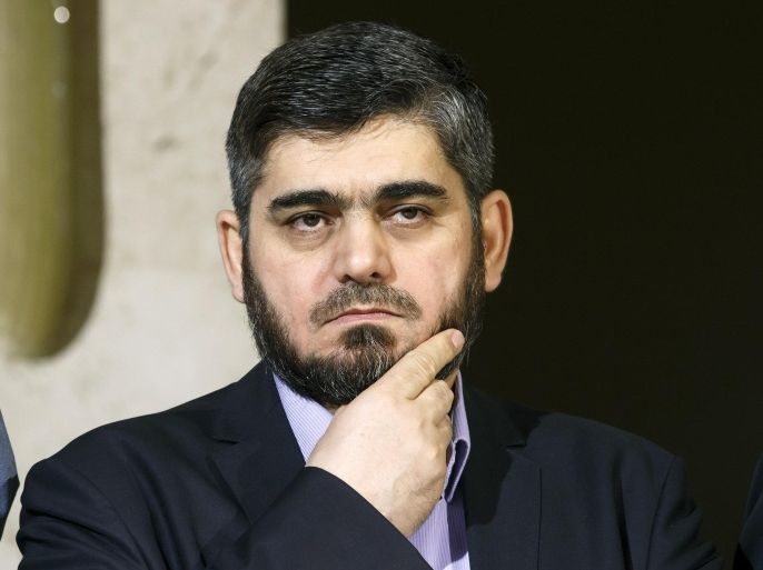 Mohammed Alloush, chief negotiator for the main Syrian opposition body and rebel group Army of Islam, listens during a briefing after a round of negotiation between the Syrian opposition and the UN Special Envoy of the Secretary-General for Syria Staffan de Mistura at the European headquarters of the United Nations in Geneva, Switzerland, Friday, April 15, 2016. (Salvatore Di Nolfi/Keystone via AP)