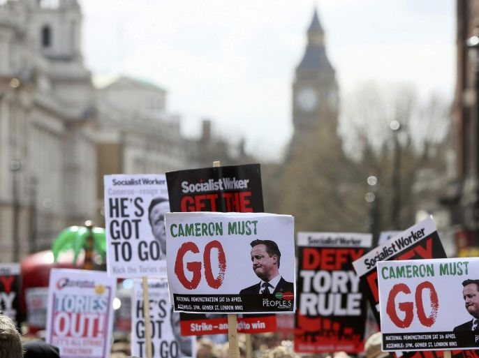 Demonstrators hold placards during a protest outside Downing Street in Whitehall, central London, Britain April 9, 2016. British Prime Minister David Cameron said on Saturday he should have handled scrutiny of his family's tax arrangements better and promised to learn the lessons after days of negative media coverage and calls for his resignation REUTERS/Neil Hall