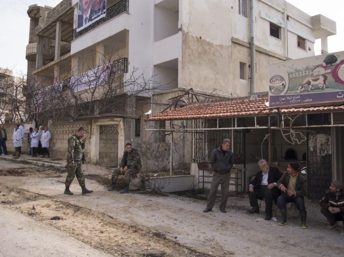 People stand on a street in Salma, Syria, Friday, Jan. 22, 2016. Syrian government forces relying on Russian air cover have recently seized Salma, located in Syria's province of Lattakia, from militants. The Syrian government offensive has given Assad a stronger hand going into peace talks with the opposition that are planned for next week in Switzerland. (AP Photo/Vladimir Isachenkov)