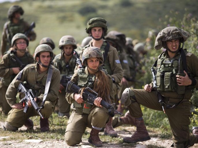 Israeli soldiers from the new mixed-sex army battalion called 'Bardelas' (Cheetah) during an urban warfare exercise near Regavim northen Israel, 29 March 2016. The Army infantry battalion called 'Bardelas' (Cheetah) established in August 2015 is the third Israeli army battalion that combined women fighters equally alongside men, Following graduation the soldiers will be stationed along the border with Jordan.
