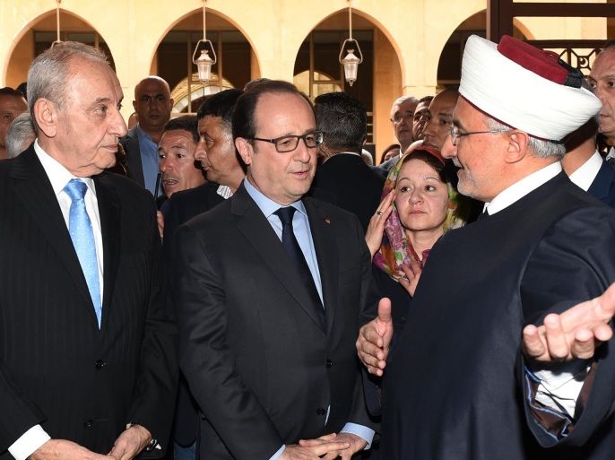 In this photo released by the Lebanese Parliament media office, French President Francois Hollande, center, stands next of Lebanese Parliament Speaker Nabi Berri, left, welcome by a Sunni sheikh during their visit to Al-Omari mosque, in downtown Beirut, Lebanon, Saturday, April 16, 2016. Hollande has arrived in Beirut at the start of a regional tour that will take him to Egypt and Jordan. During his two-day visit to Lebanon, the French president is scheduled to meet senior officials and visit a group of Syrian refugees in the country's eastern Bekaa Valley. (Ali Fawaz, Lebanese Parliament Media Office via AP)