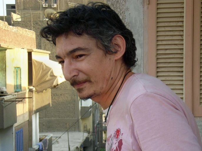 This June 2007 photo shows Eric Lang, a French resident of Cairo who died while in police custody in the Egyptian capital, Friday, Sept. 13, 2013, on the balcony of an apartment in the Sayeda Zeinab neighborhood of Cairo, Egypt. France's foreign ministry said Tuesday it was seeking details about the death of a man who Egyptian authorities say was killed by cellmates while in police custody in Cairo after being detained during a military-imposed nighttime curfew. (AP Photo/Alain Blottière)