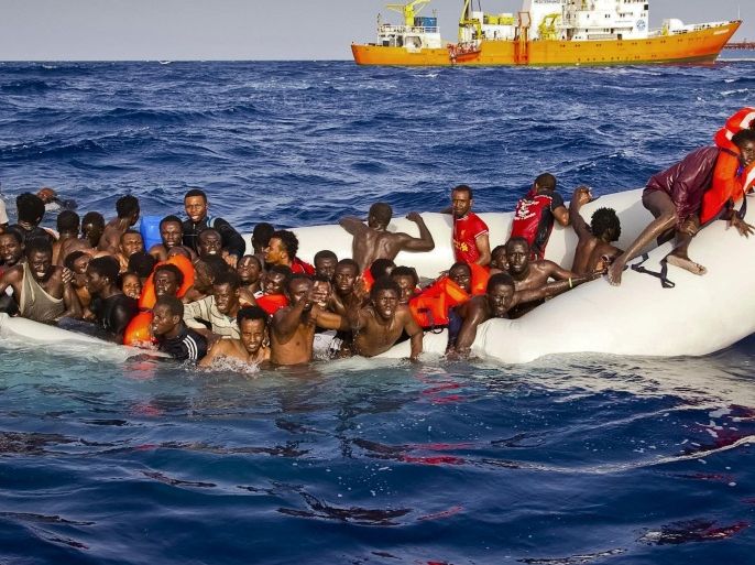 In this photo taken on Sunday, April 17, 2016 migrants ask for help from a dinghy boat as they are approached by the SOS Mediterranee's ship Aquarius, background, off the coast of the Italian island of Lampedusa. The European Union's border agency says the number of migrants crossing the Mediterranean Sea to Italy more than doubled last month. Frontex said in a statement on Monday that almost 9,600 migrants attempted the crossing, one of the most perilous sea voyages for people seeking sanctuary or jobs in Europe. (Patrick Bar/SOS Mediterranee via AP)