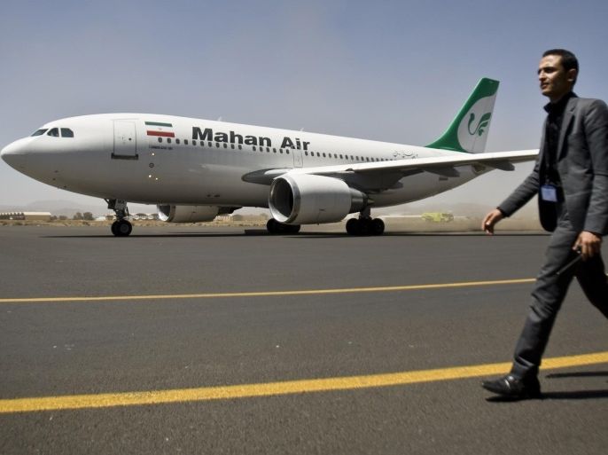 FILE -- in this Sunday, March 1, 2015 file photo, a Yemeni airport security official walks on the tarmac next to an Airbus plane from the Iranian private airline Mahan Air at the international airport in Sanaa, Yemen. Iran's Transport Minister Abbas Akhondi was quoted by the official IRNA news agency Saturday, Jan. 16, 2016, as saying his country has reached a deal with the European consortium Airbus to buy 114 passenger planes once international economic sanctions are lifted as part of a nuclear deal. (AP Photo/Hani Mohammed, File)