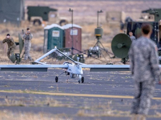 In this Oct. 20, 2015 photo, a Shadow unmanned aircraft operated by the 16th Combat Aviation Brigade comes to a stop on an airstrip at the U.S. Army Yakima Training Center in Yakima, Wash. The Army is developing the ability for Apache attack helicopter pilots to control a camera-equipped Shadow drone, allowing them to see an objective from a safer operating distance. (Peter Haley/The News Tribune via AP)