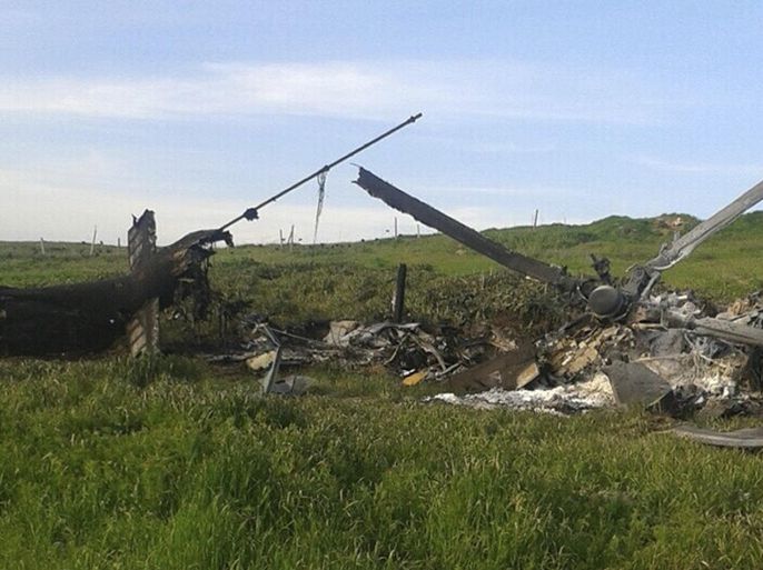 Remains of a downed Azerbaijani forces helicopter lies in a field in the separatist Nagorno-Karabakh region, on Saturday, April 2, 2016. In a statement, Azerbaijan's Defense Ministry said 12 of its soldiers "became shards" (Muslim martyrs) and said one of its helicopters was shot down. At least 30 soldiers and a boy were reported killed as heavy fighting erupted Saturday between Armenian and Azerbaijani forces over the separatist region of Nagorno-Karabakh. (AP Photo)