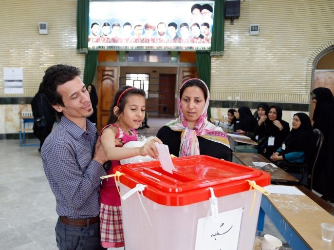 An Iranian couple with their child cast their ballot paper at a polling station during the second round of parliamentary elections at the Jameh Mosque in the city of Shahre Ghods, Iran, 29 April 2016. Polling stations opened in Iran on 29 April for the second round of parliamentary elections, in which 136 candidates are competing for 68 seats still vacant after the 26 February polls.