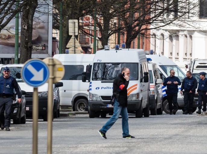 Police secure an area during a house search in the Etterbeek neighborhood in Brussels on Saturday April 9, 2016. The arrest Friday of six men suspected of links to the Brussels bombings, including the last known fugitive in last year's Paris attacks, raised new questions about the extent of the Islamic State cell believed to have carried out the intertwined attacks that left 162 people dead in two countries. (AP Photo/Geert Vanden Wijngaert)