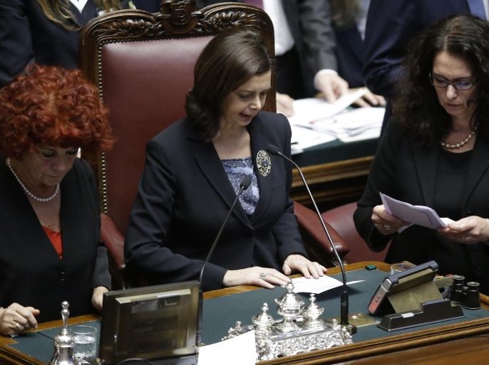 Lower chamber president Laura Boldrini, center, reads ballots at the end of a voting session for the election of the new Italian President, at the lower chamber, in Rome, Saturday, Jan. 31, 2015. Italian lawmakers vote again to elect the country's next president. Premier Matteo Renzi has urged his oft-divisive Democrats and government allies to unify behind his pick, Constitutional Court justice Sergio Mattarella, in Saturday's balloting. After two days of inconclusive balloting, the threshold for election dropped from a two-thirds majority to a simple majority. (AP Photo/Andrew Medichini)