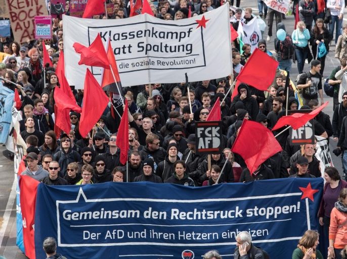 People hold banners reading 'Together we stop the move to the right' and 'Class war instead of division; as thousands of demonstrators take part in a protest in Stuttgart, Germany, 30 April 2016 against the right-wing conservative Alternative for Germany (AfD) who are holding their party national convention the city. Reports state that left wing protestors demonstrated outside the venue with the aim of stopping people attending the conference. German right-wing anti-migration Alternative for Germany (AfD) has recently come under criticism for remarks about the Islam.